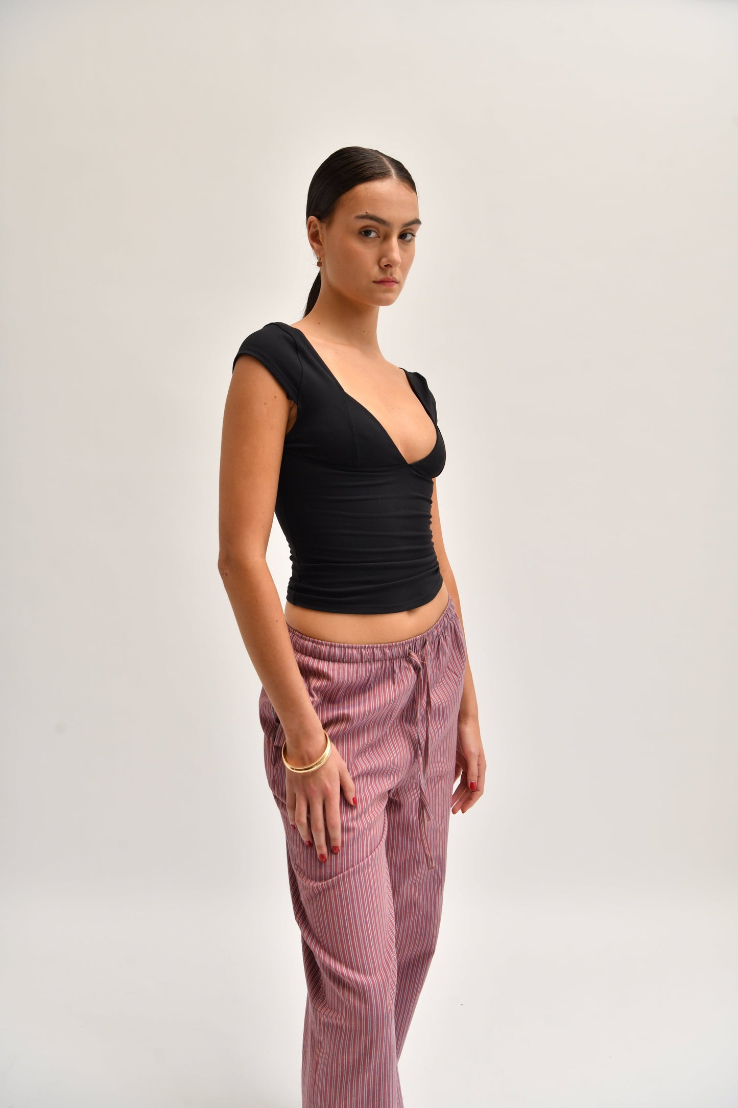 Side image of striped cotton trousers with a relaxed, wide-leg fit, designed to mimic the breezy look of linen.